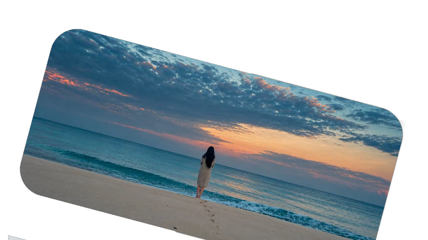 A solitary performer by the sea at sunset